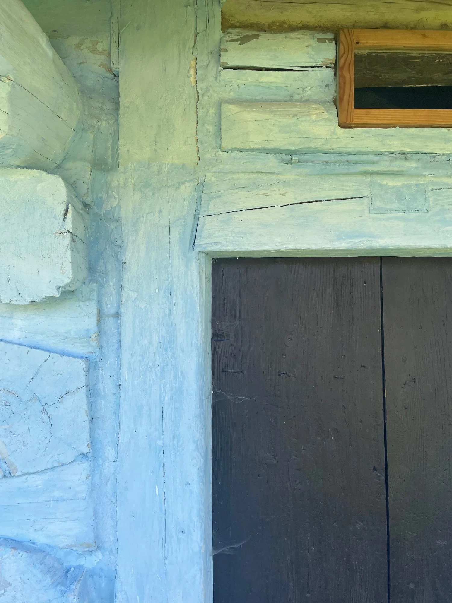 Helka stool by a traditional timber doorway